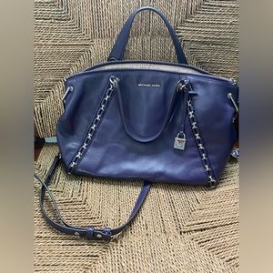 Michael Kors purple purse with silver hardware.